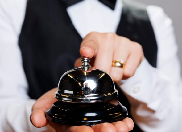 Waitress ringing hospitality bell
